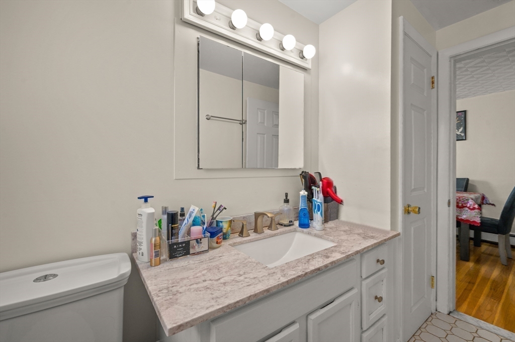 3 Athens Drive Saugus, MA 01906 - Photo 18 of 33 a bathroom with a granite countertop sink and a mirror