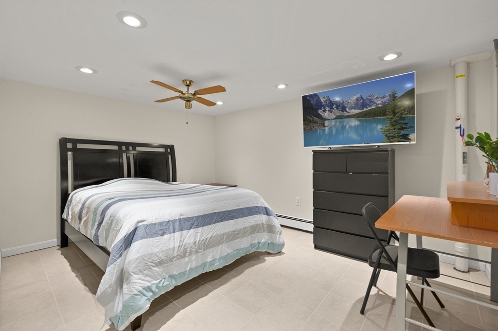 3 Athens Drive Saugus, MA 01906 - Photo 19 of 33 a bedroom with a bed and a chandelier