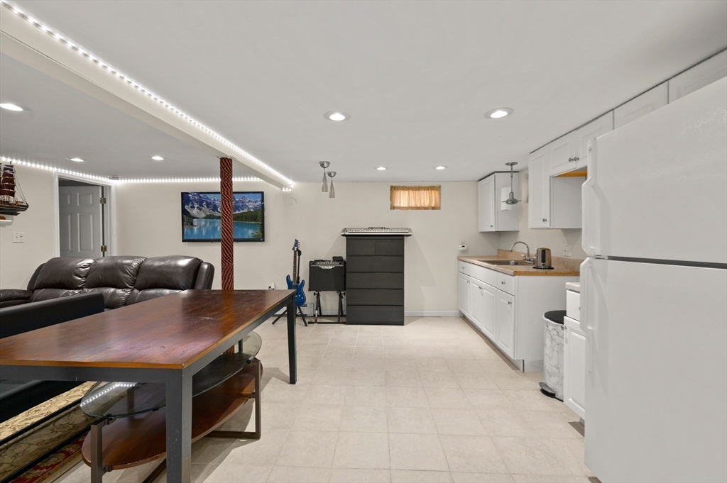 3 Athens Drive Saugus, MA 01906 - Photo 24 of 33 a open kitchen with stainless steel appliances a stove a refrigerator a sink dishwasher with a dining table and chairs