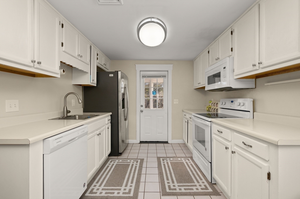 3 Athens Drive Saugus, MA 01906 - Photo 4 of 33 a kitchen with granite countertop a sink stainless steel appliances and cabinets