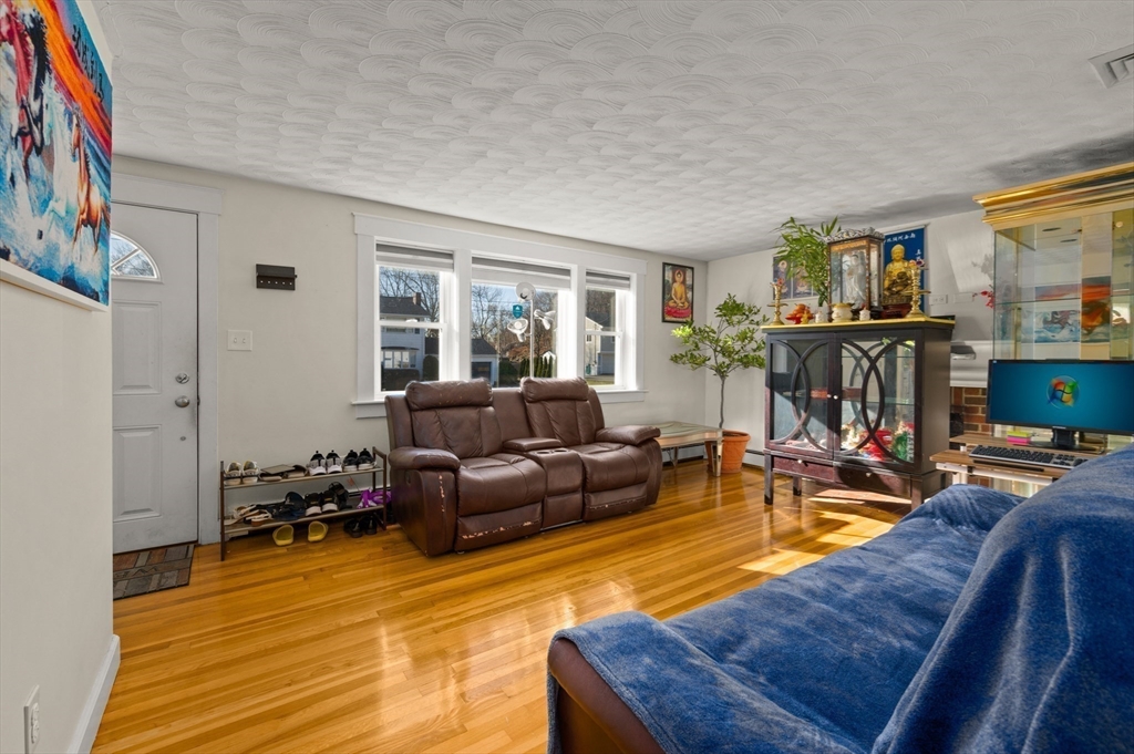3 Athens Drive Saugus, MA 01906 - Photo 8 of 33 a living room with furniture a window and a flat screen tv