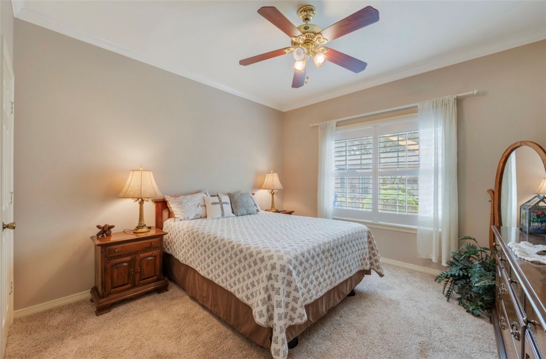 1400 Gun And Rod Road Brenham, TX 77833 - Photo 14 of 23 a bedroom with a bed and a chandelier