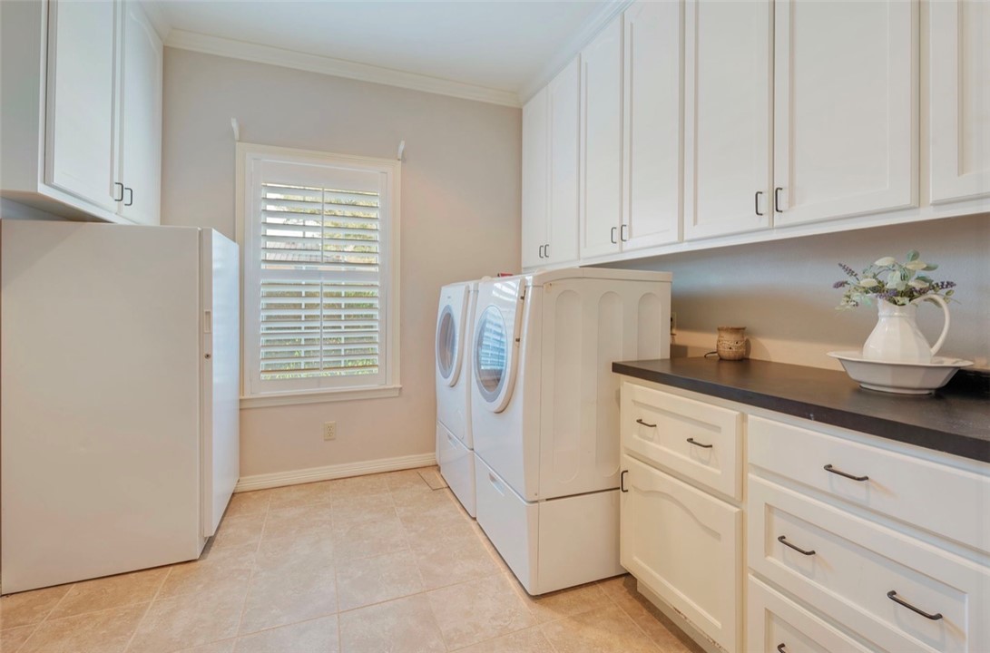 1400 Gun And Rod Road Brenham, TX 77833 - Photo 16 of 23 a kitchen with white cabinets and white appliances