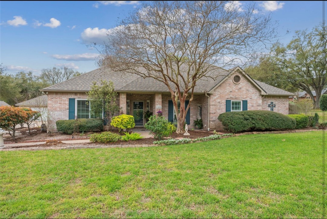 1400 Gun And Rod Road Brenham, TX 77833 - Photo 2 of 23 a front view of a house with a yard and garage