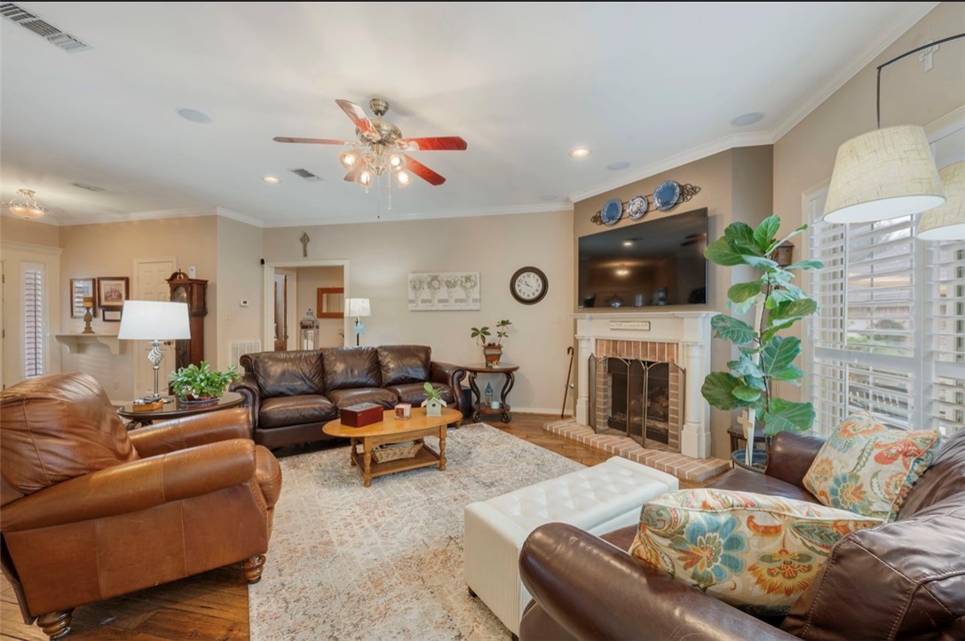 1400 Gun And Rod Road Brenham, TX 77833 - Photo 3 of 23 a living room with furniture a fireplace and a flat screen tv