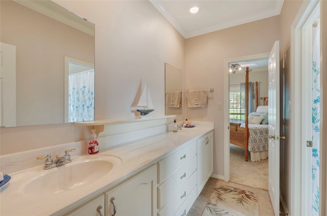 1400 Gun And Rod Road Brenham, TX 77833 - Photo 10 of 23 a en suite bathroom with a double vanity sink and mirror