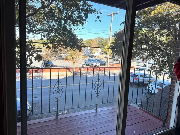 a view of a balcony with wooden floor