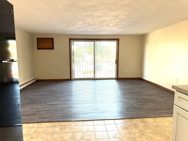 a view of wooden floor and windows in a room