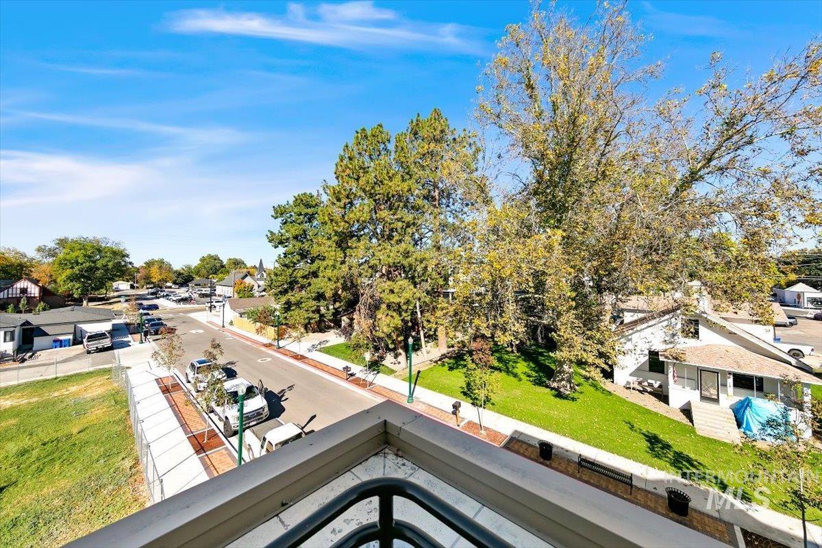 79 East Aikens Road, Unit 304 Eagle, ID 83616 - Photo 31 of 42 Expansive balcony featuring a wood-finish floor, arched opening, and durable metal railings