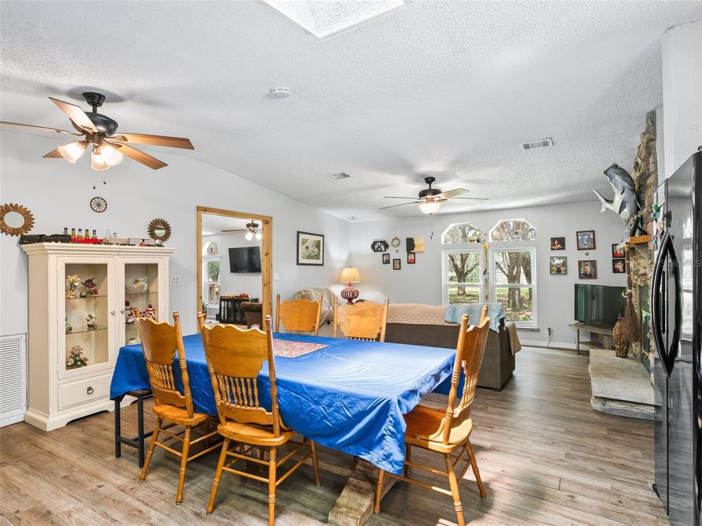 17090 Southeast 173rd Terrace Road Weirsdale, FL 32195 - Photo 15 of 54 a living room with furniture and wooden floor