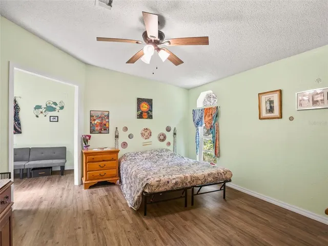 a bed room with a bed and a chandelier