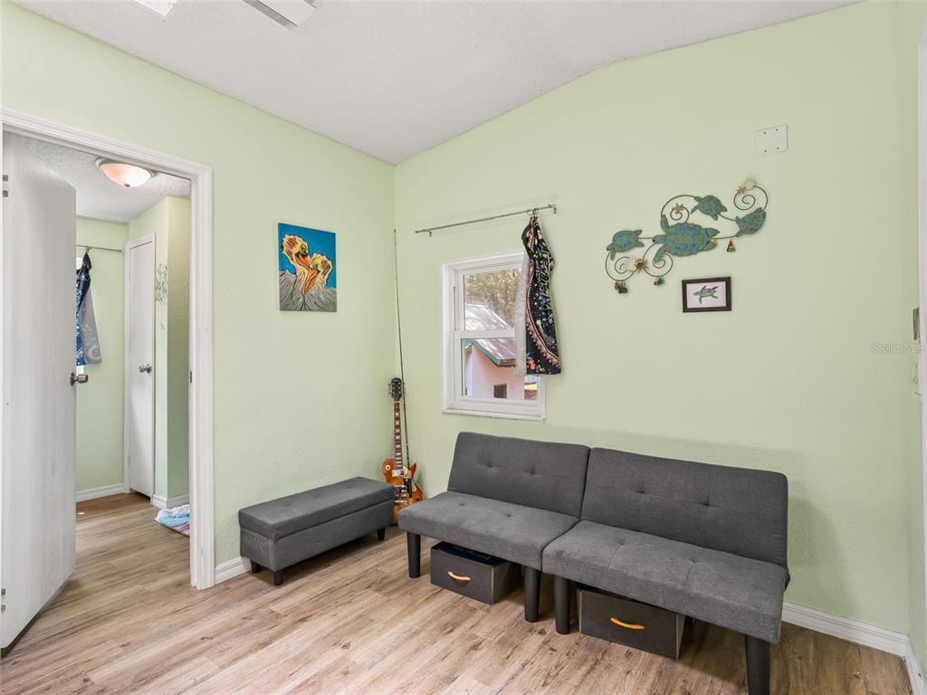 17090 Southeast 173rd Terrace Road Weirsdale, FL 32195 - Photo 18 of 54 a living room with couch and a wooden floor