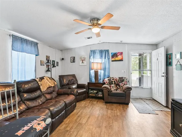 a very nice looking open dining room with kitchen island a stove a sink a dining table and chairs