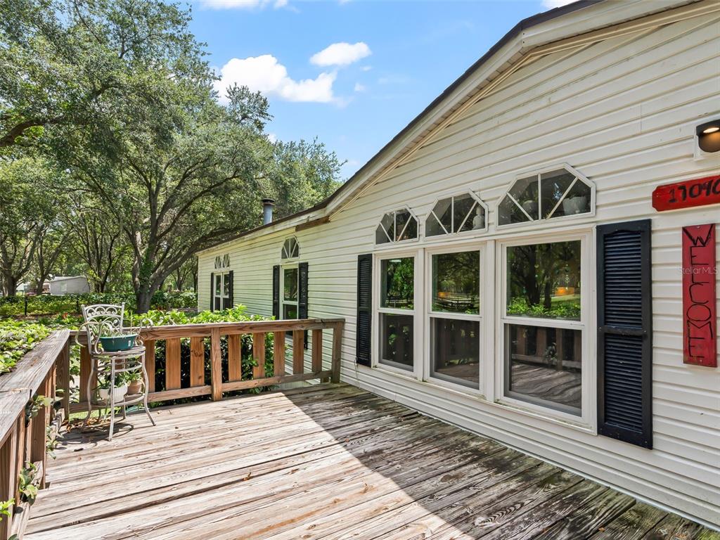 17090 Southeast 173rd Terrace Road Weirsdale, FL 32195 - Photo 4 of 54 a view of a house with a deck