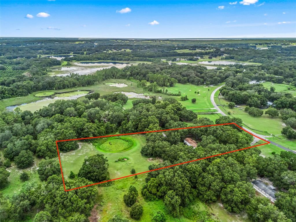 17090 Southeast 173rd Terrace Road Weirsdale, FL 32195 - Photo 51 of 54 an aerial view of a houses with outdoor space and city view