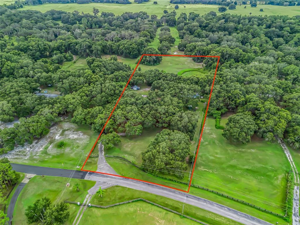 17090 Southeast 173rd Terrace Road Weirsdale, FL 32195 - Photo 52 of 54 an aerial view of residential houses with outdoor space and trees