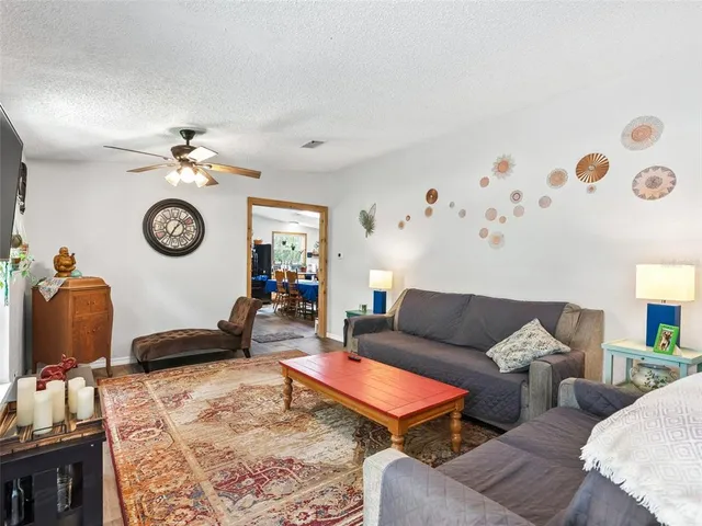 a living room with furniture a rug and a window