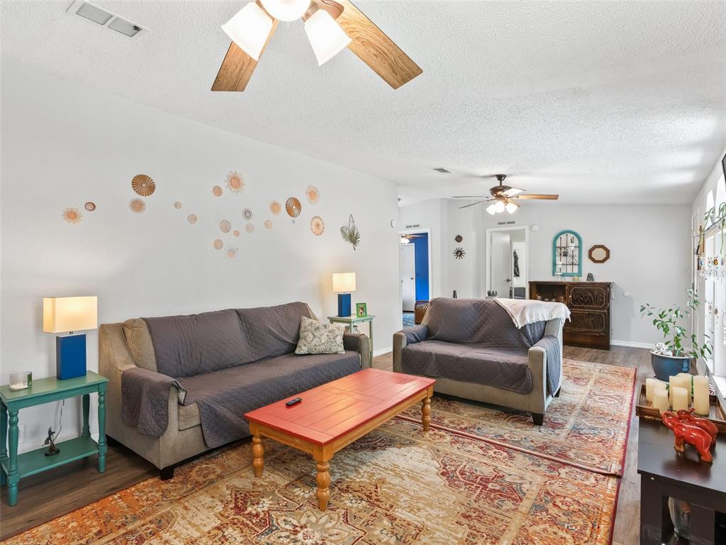 17090 Southeast 173rd Terrace Road Weirsdale, FL 32195 - Photo 8 of 54 a living room with furniture and wooden floor