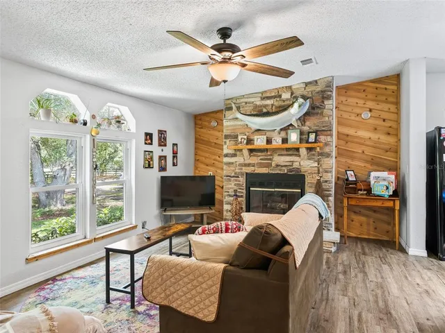 a living room with furniture a fireplace and a flat screen tv