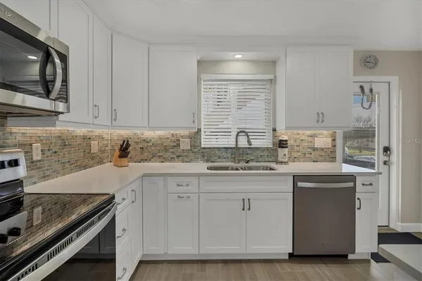 a kitchen with a sink stove and cabinets