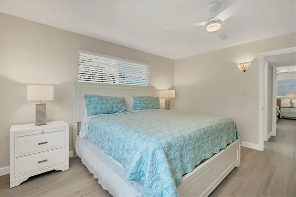 a bedroom with a bed and a night stand
