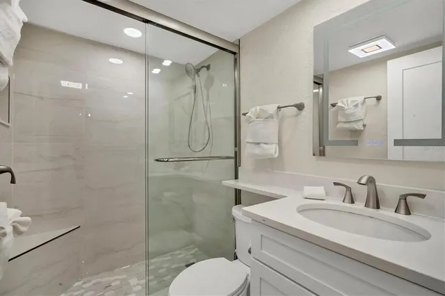 a bathroom with a sink toilet and shower