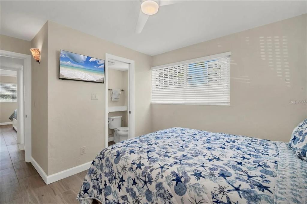 6006 Midnight Pass Road, Unit 36 Sarasota, FL 34242 - Photo 20 of 43 a bedroom with a bed and a window