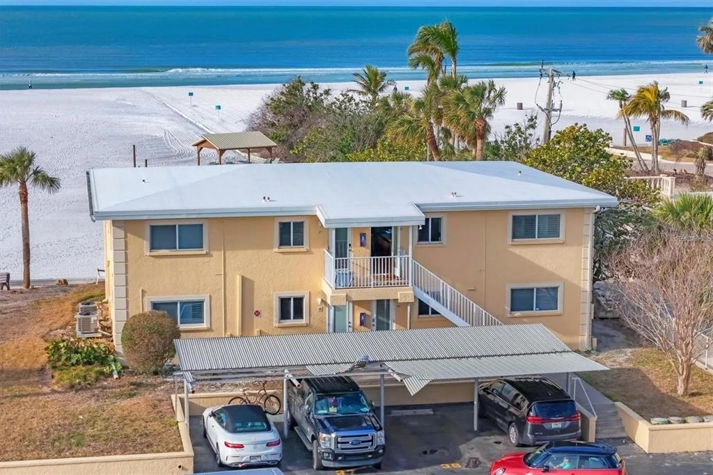 6006 Midnight Pass Road, Unit 36 Sarasota, FL 34242 - Photo 2 of 43 a front view of a house with garden