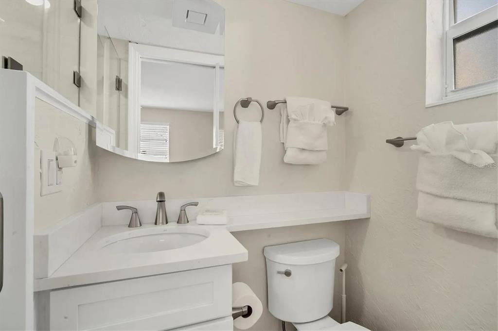 6006 Midnight Pass Road, Unit 36 Sarasota, FL 34242 - Photo 21 of 43 a bathroom with a sink toilet and mirror