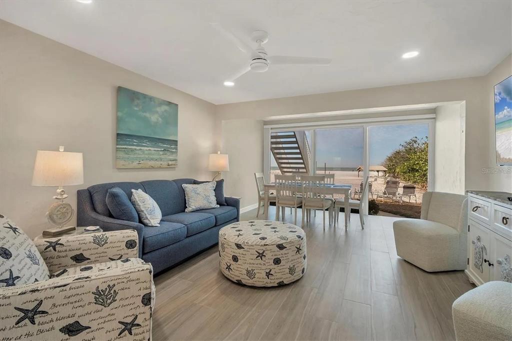 6006 Midnight Pass Road, Unit 36 Sarasota, FL 34242 - Photo 6 of 43 a living room with furniture and a large window