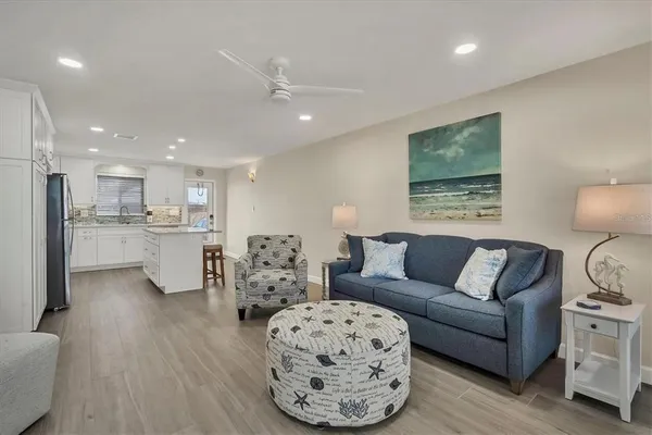 a living room with furniture and kitchen view