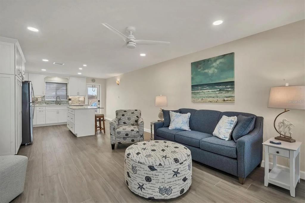 6006 Midnight Pass Road, Unit 36 Sarasota, FL 34242 - Photo 7 of 43 a living room with furniture and kitchen view