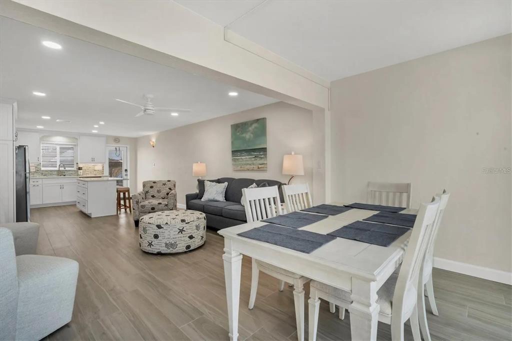 6006 Midnight Pass Road, Unit 36 Sarasota, FL 34242 - Photo 8 of 43 a living room with furniture and a table