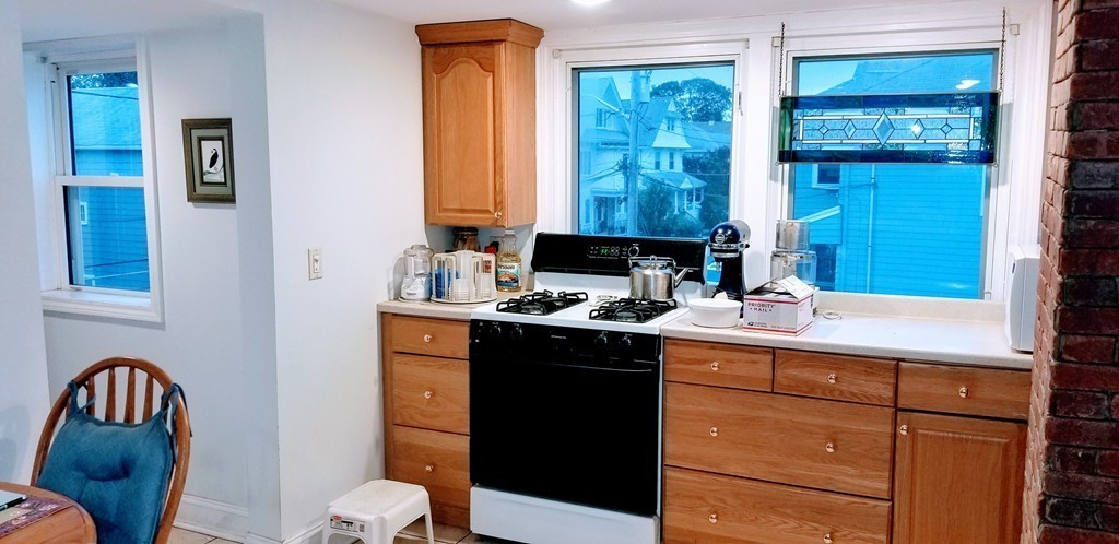 58 Dearborn Street Medford, MA 02155 - Photo 14 of 30 a kitchen with a sink cabinets and a stove