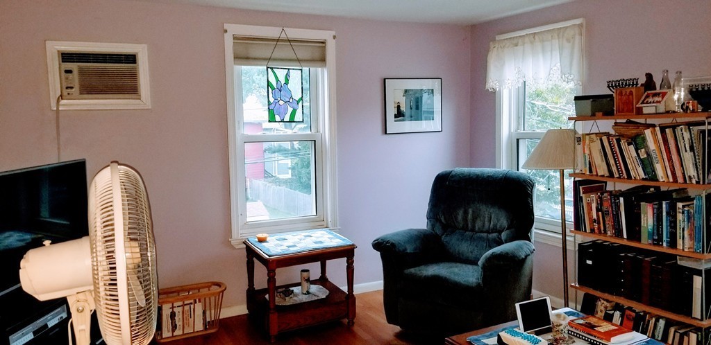 58 Dearborn Street Medford, MA 02155 - Photo 19 of 30 a living room with furniture bookshelf and a window
