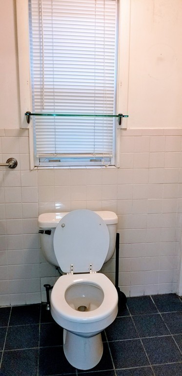 58 Dearborn Street Medford, MA 02155 - Photo 24 of 30 a bathroom with a toilet a sink and a window