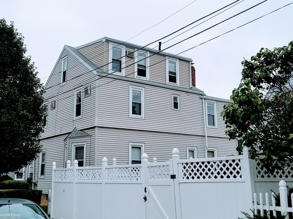 58 Dearborn Street Medford, MA 02155 - Photo 8 of 30 a view of a house with a large window and wooden fence