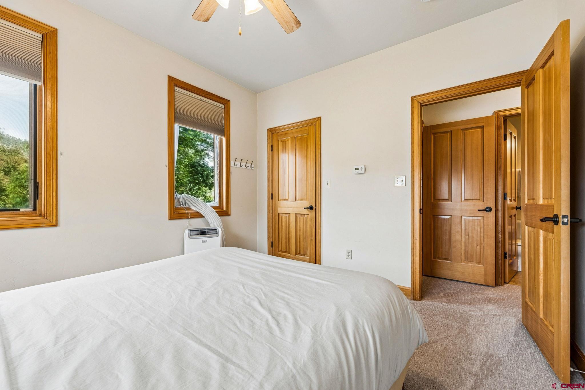 1422 Animas View Drive, Unit 55 Durango, CO 81301 - Photo 35 of 44 a bedroom with a bed and a chandelier