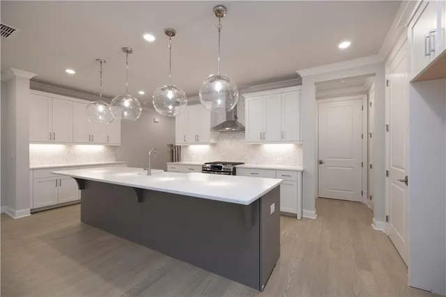 a kitchen with a sink stainless steel appliances and cabinets