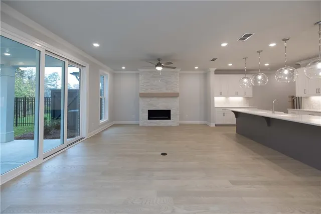 a large white kitchen with a large tub a sink and a fireplace