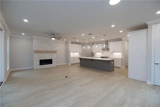 a view of an empty room with a fireplace and a window