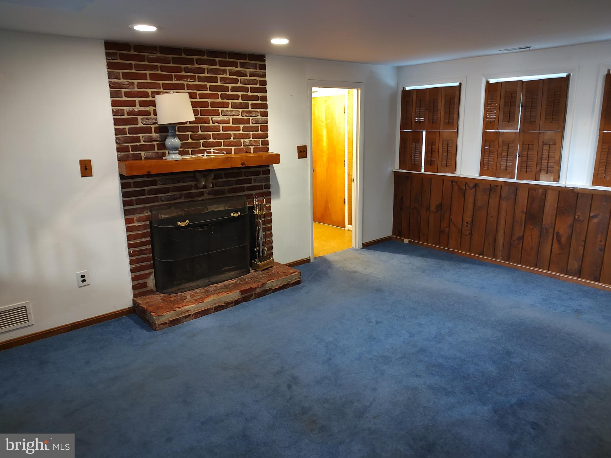 603 Perth Place Silver Spring, MD 20901 - Photo 3 of 16 a view of an empty room with wooden floor and a fireplace