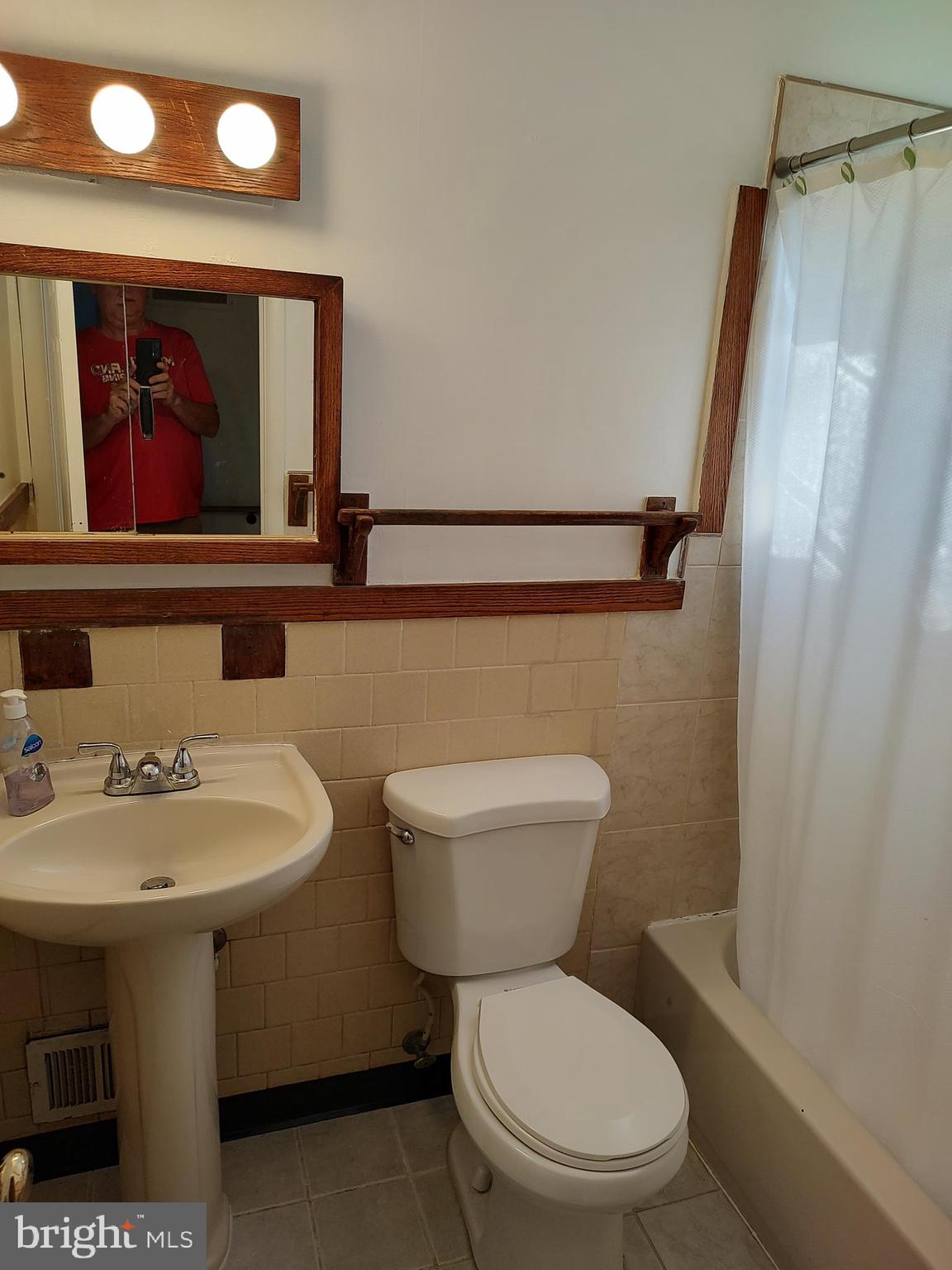 603 Perth Place Silver Spring, MD 20901 - Photo 7 of 16 a bathroom with a toilet a sink and mirror