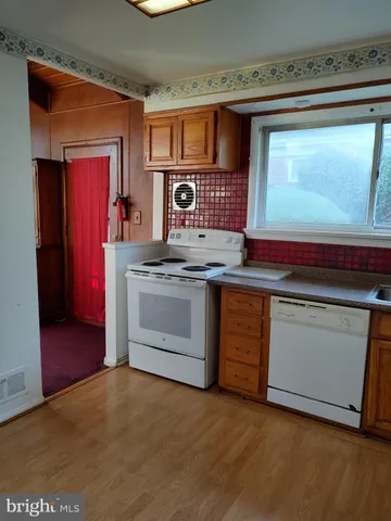 a kitchen with stainless steel appliances granite countertop a stove and a microwave