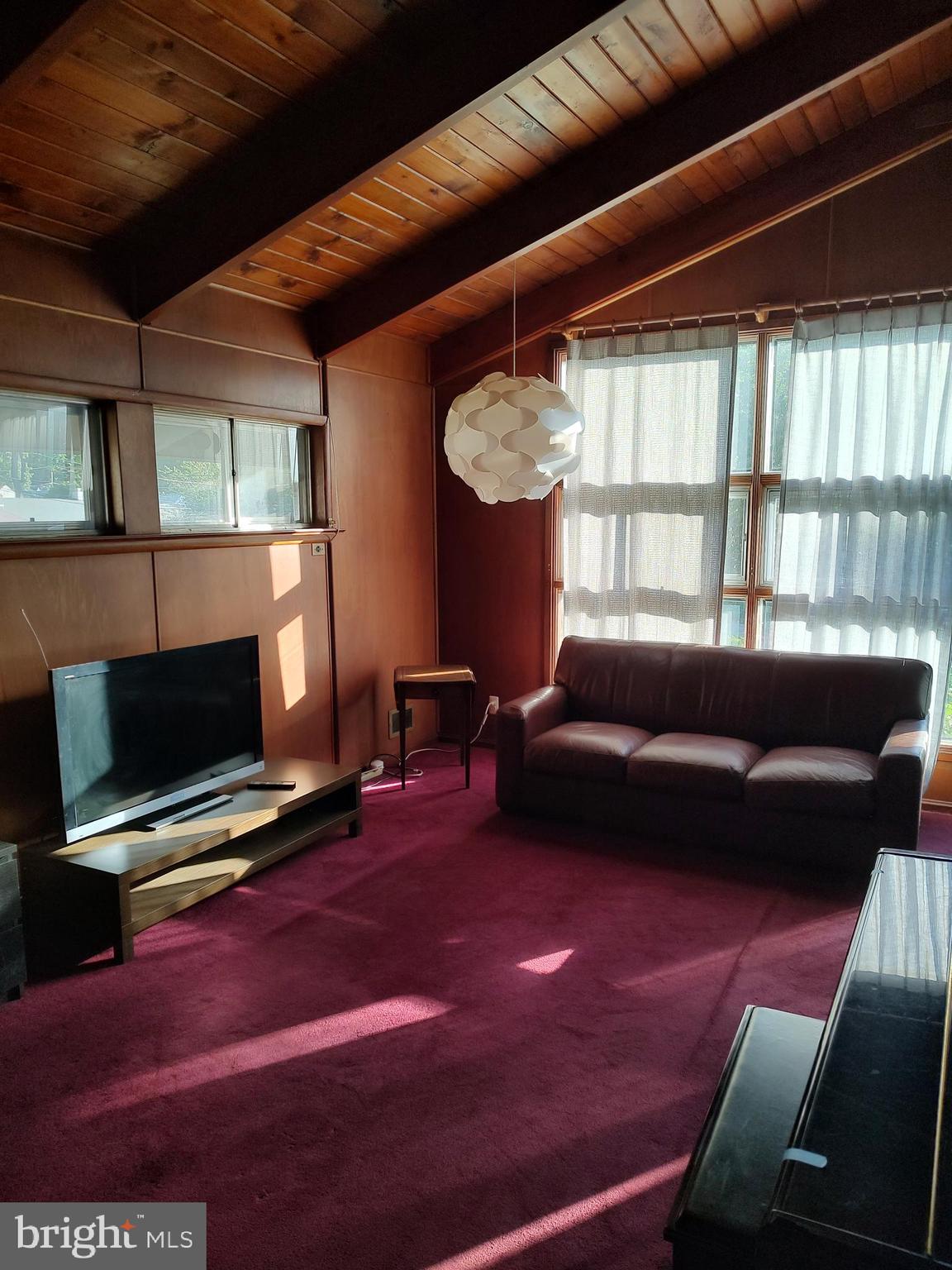 603 Perth Place Silver Spring, MD 20901 - Photo 10 of 16 a living room with furniture a flat screen tv and a fireplace
