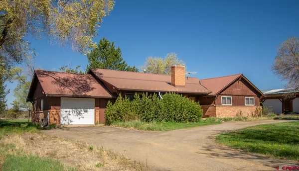 a front view of a house with a garden and porch