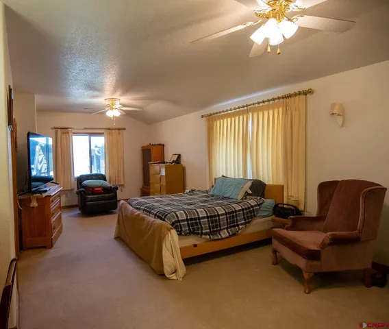 a spacious bedroom with a bed and a couch