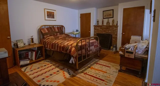 a bedroom with a bed and a fireplace
