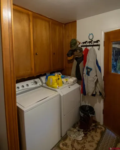 a view of storage and utility room with washer and dryer