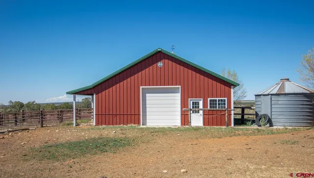 a view of a house with a yard and garage